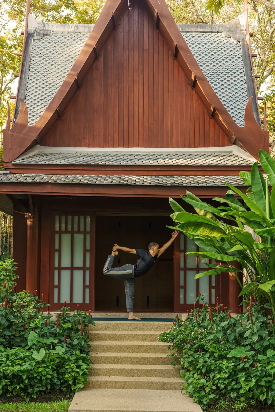 A yoga practitioner in dancer pose at the entrance of the Yoga Sala at Chiva-Som Hua Hin